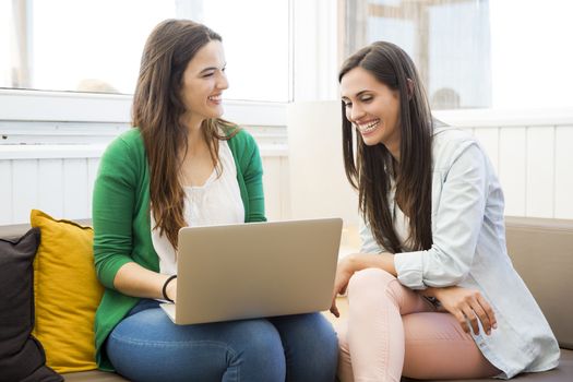 Female friends at the local coffee shop drinking coffee and working