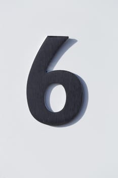 Number 6 on a Post Box with white backgound.