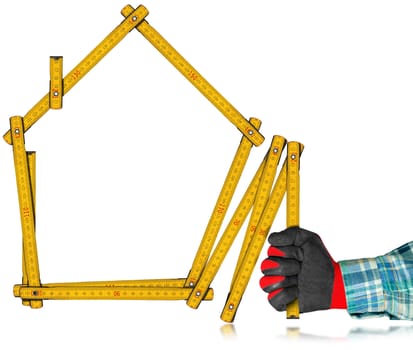 Hand with red and black work glove holding a yellow wooden meter ruler in the shape of house isolated on white background. Concept of house project 