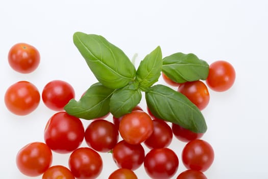  fresh cherry tomatoes with basil, on white background