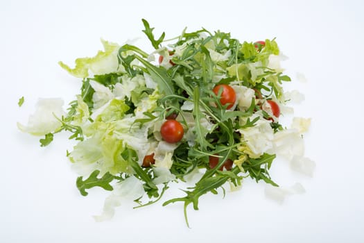 Heap of ruccola, lettuce leaves and cherry tomatoes