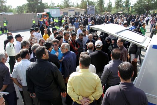 IRAN, Tehran: Family and friends gather at the Behesht-e Zahra cemetery on October 4, 2015 to say their final farewells to loved ones lost in the Mena tragedy. A total of 465 Iranian pilgrims lost their lives in the large stampede of people at the Hajj rituals on September 24, 2015. The pilgrims were on their way to participate in the symbolic stoning of the Satan in the Mena neighbourhood of Mecca, Saudi Arabia. 