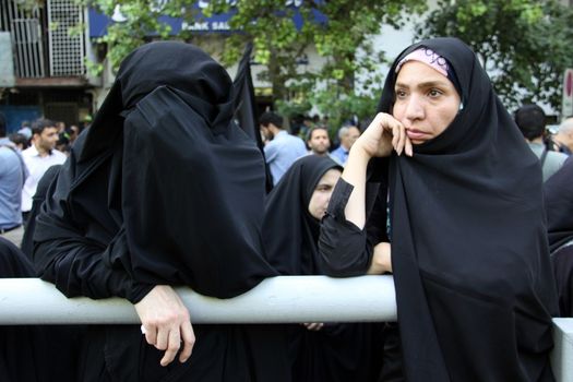IRAN, Tehran: Family and friends gather at the Behesht-e Zahra cemetery on October 4, 2015 to say their final farewells to loved ones lost in the Mena tragedy. A total of 465 Iranian pilgrims lost their lives in the large stampede of people at the Hajj rituals on September 24, 2015. The pilgrims were on their way to participate in the symbolic stoning of the Satan in the Mena neighbourhood of Mecca, Saudi Arabia. 