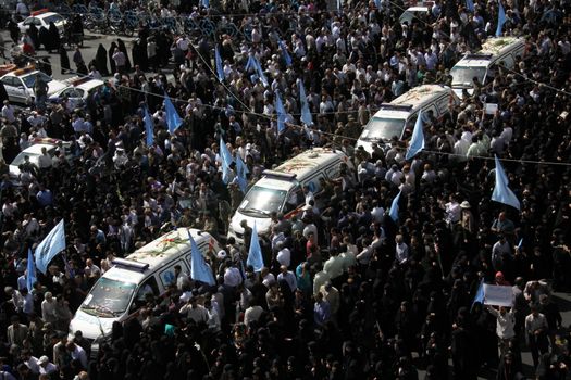 IRAN, Tehran: Family and friends gather at the Behesht-e Zahra cemetery on October 4, 2015 to say their final farewells to loved ones lost in the Mena tragedy. A total of 465 Iranian pilgrims lost their lives in the large stampede of people at the Hajj rituals on September 24, 2015. The pilgrims were on their way to participate in the symbolic stoning of the Satan in the Mena neighbourhood of Mecca, Saudi Arabia. 
