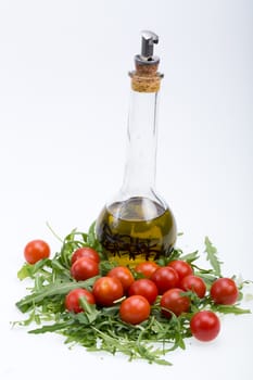 Heap of ruccola, tomatoes and olive oil with the thyme