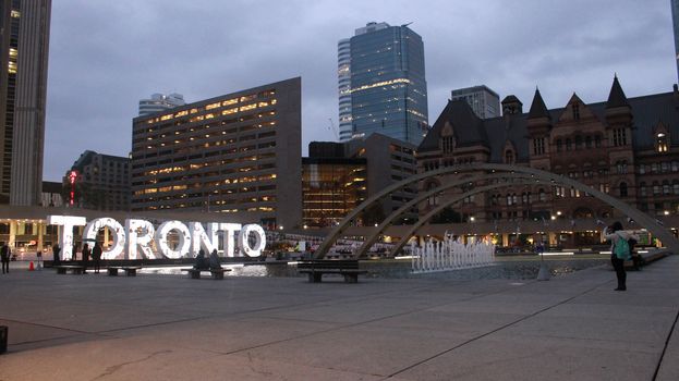 CANADA, Toronto:  Nathan Phillips Square as the sun comes up during Nuit Blache on October 4, 2015.Nathan Phillips Square featured Inside Out, a participatory art project that allowed people to have their portraits printed and added to the exhibit, the portraits also covered the 'Toronto' sign. 