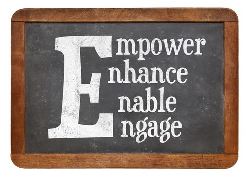 Empower, enhance, enable, engage word abstract - white chalk text on a vintage slate blackboard