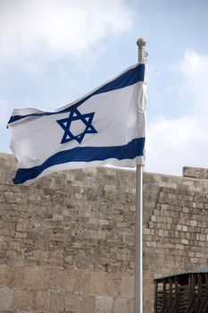 Flag of state of Israel over western wall in jerusalem