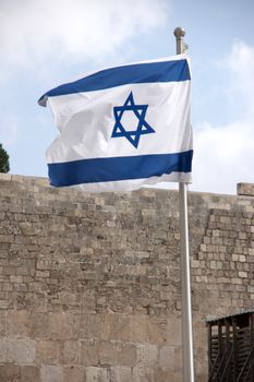 Flag of state of Israel over western wall in jerusalem