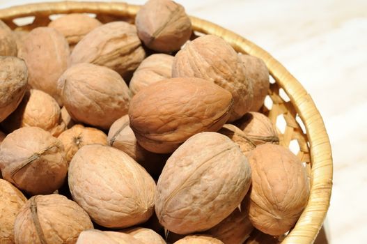 walnuts in shell in basket stock photo