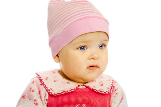 Portrait of blue-eyed baby in a pink dress and hat