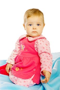 Little girl baby in a dress sitting on the floor