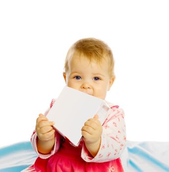 baby girl in a dress sitting and holding a box