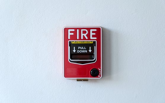 Fire alarm switch on white wall