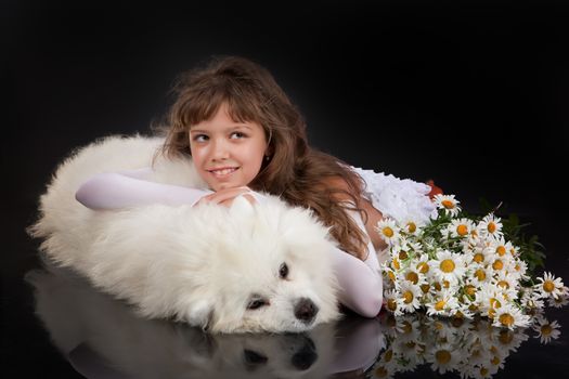 Girl and white Samoyed dog in the studio
