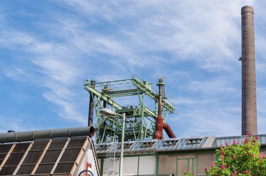 Chimney of an old factory against blue sky in the North Duisburg Landscape Park.