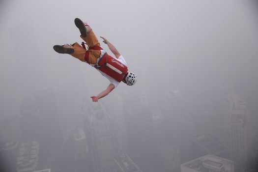 MALAYSIA, Kuala Lumpur: Base jumper hurls head first off KL Tower	Heavy haze didn't deter the 120 thrill-seeking base jumpers as they leapt into the foggy abyss off Kuala Lumpur Tower on October 3, 2015.  	The participants were joining others across the world on the 15th�International Base Jump Day. 