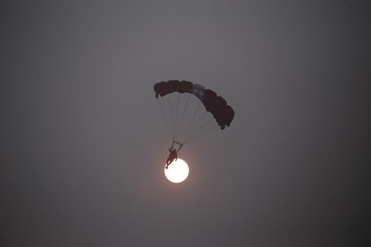 MALAYSIA, Kuala Lumpur: Base jumper silhouetted by sun through haze	Heavy haze didn't deter the 120 thrill-seeking base jumpers as they leapt into the foggy abyss off Kuala Lumpur Tower on October 3, 2015.  	The participants were joining others across the world on the 15th�International Base Jump Day. 