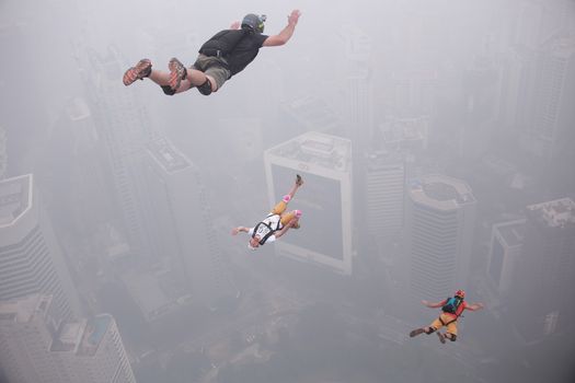 MALAYSIA, Kuala Lumpur: Base jumpers launch into abyss	Heavy haze didn't deter the 120 thrill-seeking base jumpers as they leapt into the foggy abyss off Kuala Lumpur Tower on October 3, 2015.  	The participants were joining others across the world on the 15th�International Base Jump Day. 