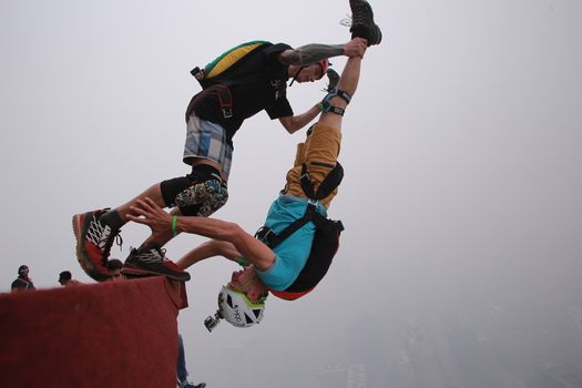 MALAYSIA, Kuala Lumpur: Base jumpers	Heavy haze didn't deter the 120 thrill-seeking base jumpers as they leapt into the foggy abyss off Kuala Lumpur Tower on October 3, 2015.  	The participants were joining others across the world on the 15th�International Base Jump Day. 