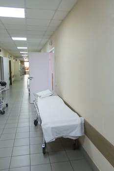 Photo of empty stretcher in hospital corridor