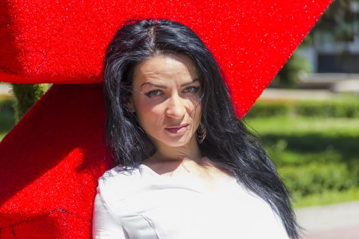 Caucasian brunette woman in white on red