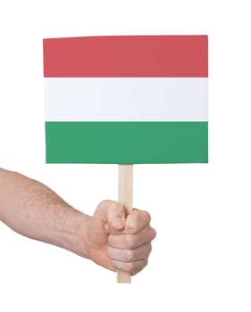 Hand holding small card, isolated on white - Flag of Hungary