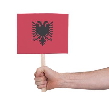 Hand holding small card, isolated on white - Flag of Albania