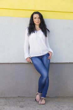 European young brunette on background white wall