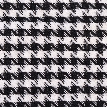 The woolen black-and-white fabric in a cage