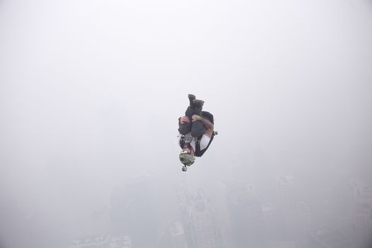 MALAYSIA, Kuala Lumpur: Base jumper 	Heavy haze didn't deter the 120 thrill-seeking base jumpers as they leapt into the foggy abyss off Kuala Lumpur Tower on October 3, 2015.  	The participants were joining others across the world on the 15th�International Base Jump Day. 
