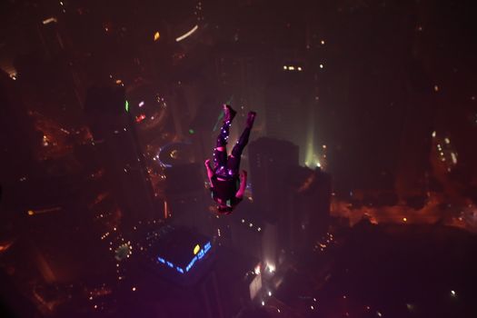 MALAYSIA, Kuala Lumpur: night Base jump	Heavy haze didn't deter the 120 thrill-seeking base jumpers as they leapt into the foggy abyss off Kuala Lumpur Tower on October 3, 2015.  	The participants were joining others across the world on the 15th�International Base Jump Day. 