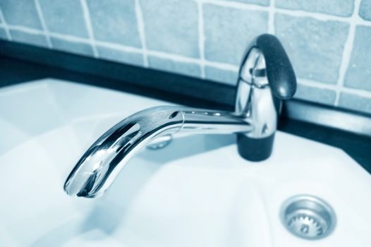 Water conceptual image. Close up of a tap in kitchen.