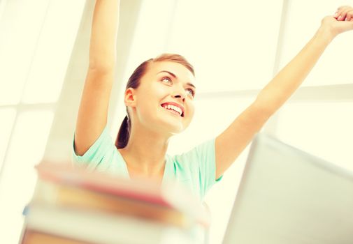 education concept - happy student girl with computer at school