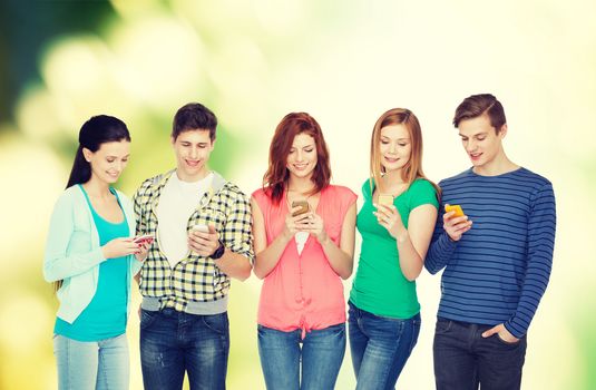 education and modern technology concept - smiling students with smartphones