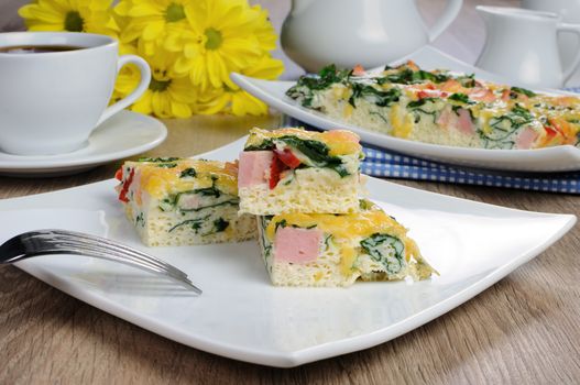 Canape of omelet with spinach, sausage and a cup of coffee