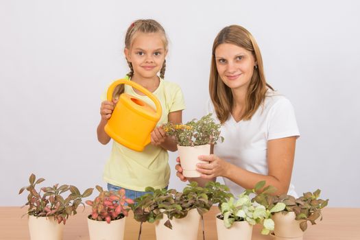 Mother and daughter six years of caring and watering potted plants