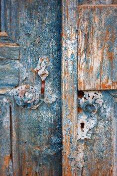 Close-up view on the old door with rusty metal details