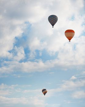 Three air balloons  in blue sky. Vertical photo