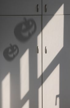 Shadow of Halloween pumpkin on the cabinet