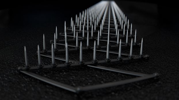 A sharp spike strip spread over dark wet tarmac