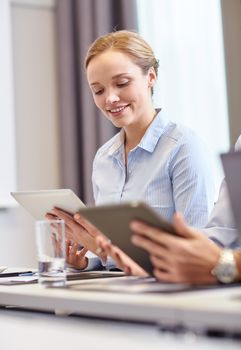 business, people and technology concept - smiling woman holding tablet pc computer