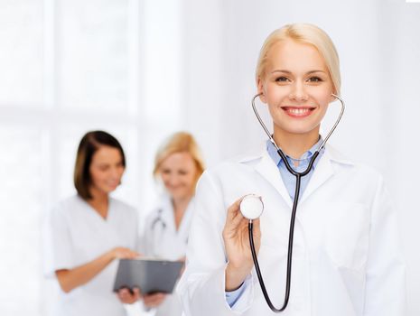 healthcare and medicine concept - smiling female doctor with stethoscope