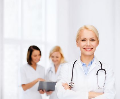 healthcare and medicine concept - smiling female doctor with stethoscope