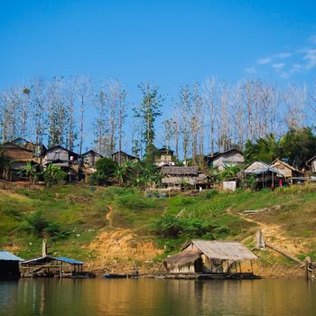 Floating houses by Songalia river in a folk village in Sangklaburi, Kanchanaburi, Thailand