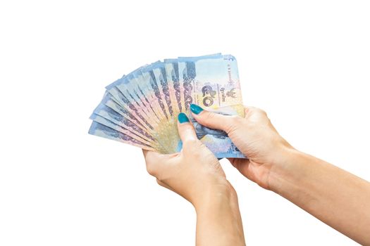 Thai Banknote money in female hand, isolated on white background