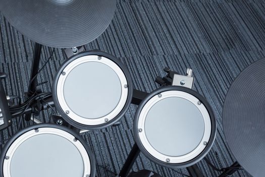 Electronic drum set in the room corner as musical background technology theme, top view