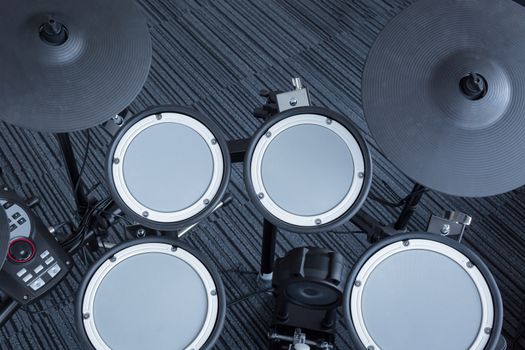 Electronic drum set in the room corner as musical background technology theme, top view