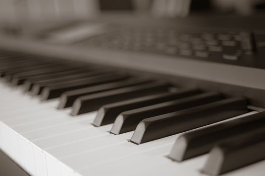 abstract blur of Piano Keyboard synthesizer closeup key frontal view, vintage theme