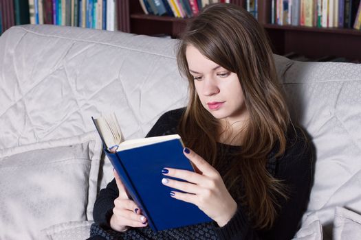 Woman at the library reading a book